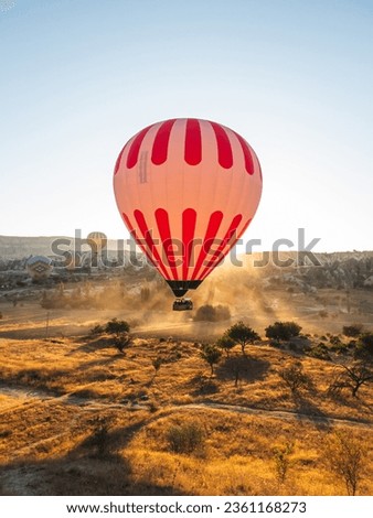 Hot air balloons in Cappadocia at dawn. Incredibly beautiful landscapes and panoramic views. Vivid photos of tourist attractions.