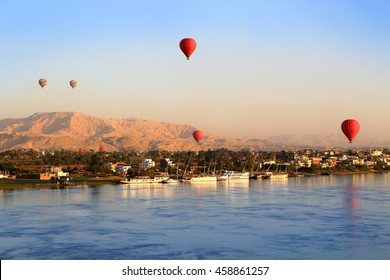 Hot Air Balloons Floating Over The Nile River In Luxor At Sunrise