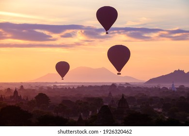 Hot air balloons fly over the ancient pagodas of old Bagan in Myanmar at sunrise. Bagan, Myanmar. - Powered by Shutterstock