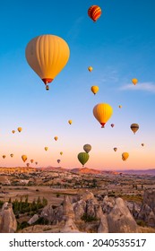 Hot air balloons flying on sunset sky in Cappadocia, Turkey - Shutterstock ID 2040535517