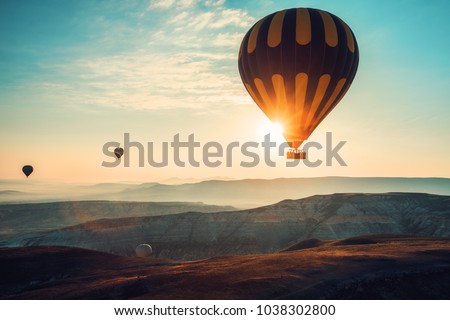 Hot air balloons flying over the valley at Cappadocia, Turkey. 