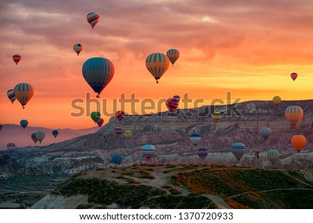 Hot Air balloons flying tour over Mountains landscape spring sunrice Cappadocia, Goreme National Park, Turkey nature background. 