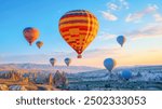 Hot air balloons hovering in the sky on sunrise in Cappadocia, Turkey