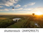 Hot air balloons in Pokolbin wine region near hunter vally gardens as sunrise aerial photo, Hunter Valley, NSW, Australia	