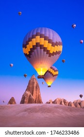 Hot air balloons taking off at sunrise. It is a nice activity for tourists who want to see the historical points and fairy chimneys of Cappadocia from the air every morning.