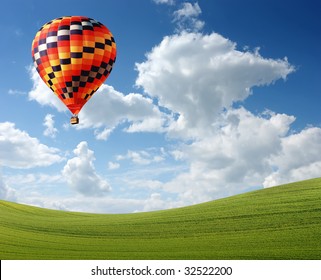 Hot Air Baloon Floating In The Sky Over Land