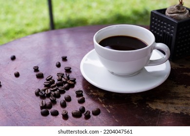 Hot Americano Coffee On An Old Wooden Table.. A Cup Of Coffee On A Plate.  Americano Black Coffee On Wooden Floor  Afternoon Is The Best Time To Drink Coffee.