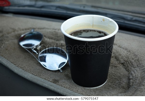 Hot Americano\
coffee in take away cup in\
car