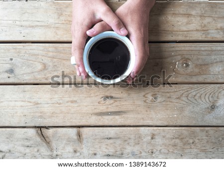 Hot americano cup with wooden background