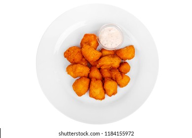 Hot appetizer chicken nuggets in crispy golden breadcrumbs, fried in oil, mayonnaise sauce, tar-tar, before alcohol, on plate, white isolated background view from above. For the menu, restaurant, cafe