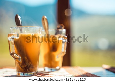 Hot apple cider with mountains in the background. Seasonal outdoor concept