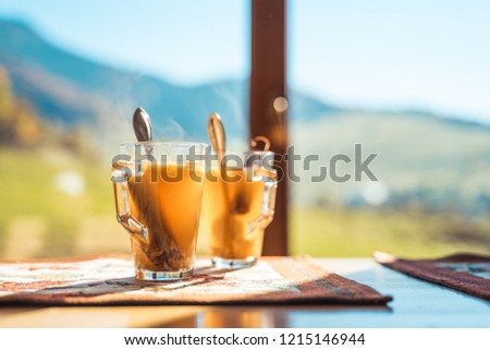 Hot apple cider with mountains in the background. Seasonal outdoor concept