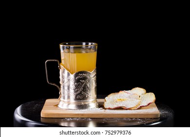 Hot Apple Cider Served With Dried Apple And Cookie Isolated On Black Background