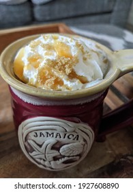 Hot Apple Cider Topped With Whipped Cream, Carmel Sauce, And Brown Sugar