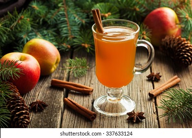 Hot apple cider traditional winter season drink with cinnamon and anise. Homemade healthy organic warm spice beverage. Christmas or thanksgiving holiday decoration on vintage wooden background. - Powered by Shutterstock