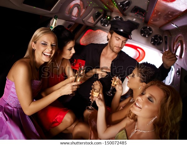 Hot bachelorette party party in\
limousine with handsome chauffeur and beautiful\
girls.