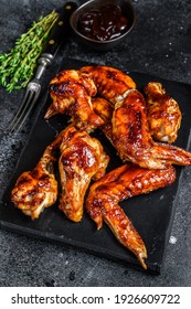 Hot Barbecue Chicken Wings With Sauce Bbq. Black Background. Top View.