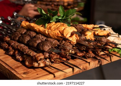 Hot Barbecue From Different Types Of Meat Straight From The Grill And Coals, Photo With Poor Lighting But In Detail.