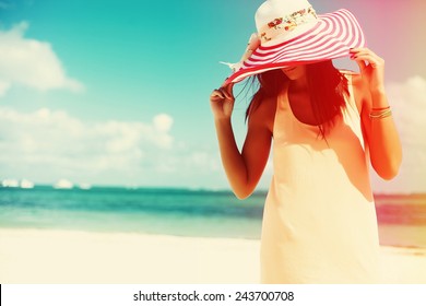 Hot Beautiful Woman In Colorful Sunhat And Dress Walking Near Beach Ocean On Hot Summer Day On White Sand