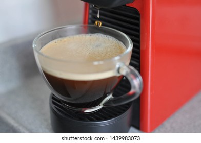 Hot black coffee fresh made by capsule coffee machine in a coffee cup ready for serve or drink. Shot from high angle under natural morning light condition. - Powered by Shutterstock