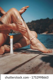 Hot body woman using sun protection cream outdoors on her shaped legs - Shutterstock ID 1752998663