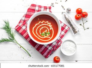 Hot Bowl Of Tomato Basil Soup With Mayo, Squared Rustic Napkin, Salt And Pepper, Topview