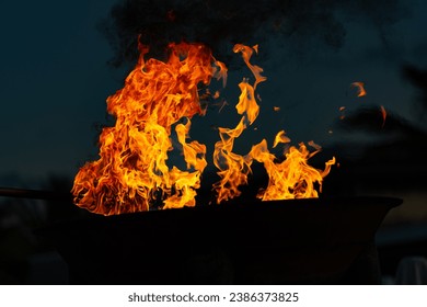 Hot bright Flame seemingly dancing against dark of night.