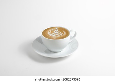 Hot cafe Latte espresso coffee in white ceramic cup on saucer with rosetta latte art isolated in white background. - Powered by Shutterstock