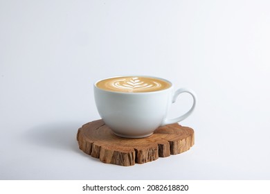 Hot cafe Latte espresso coffee in white ceramic cup on wood saucer with rosetta latte art isolated in white background. - Shutterstock ID 2082618820