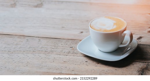 hot cappucino coffee cup on wood table banner