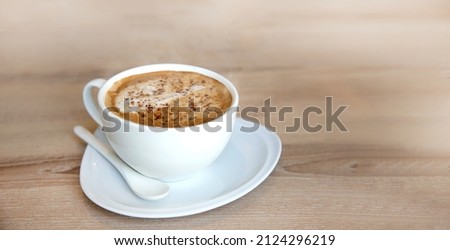 hot cappucino coffee cup on wood table in morning 