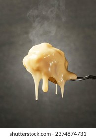 Hot cheese dripping from the forks in a close up view 