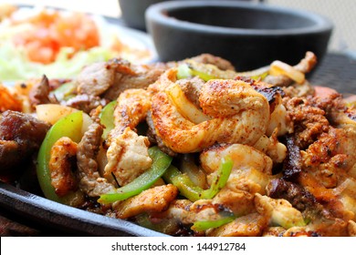 Hot Chicken, Beef And Shrimp Fajitas On A Skillet