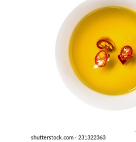 Hot Chili Oil In Bowl, Isolated On White Background