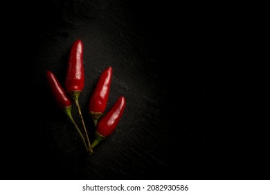 hot chili pepper over black stone background