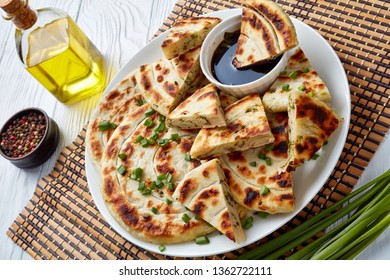 Hot Chinese Spring Onion Pancakes With Soy Sauce On A Plate On A White Wooden Table, View From Above, Close-up