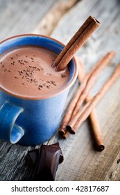 Hot Chocolate With Cinnamon Stick In Blue Cup