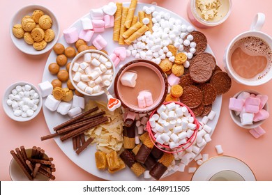 Hot Chocolate, Marshmallows, Chocolates And Cookies Charcuterie Board On Pink Background. Closeup View, Horizontal Orientation