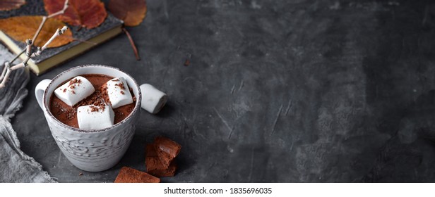 Hot chocolate and marshmallows. Hot Cocoa in a white cup. Dark background. Autumn drink concept. Copy space. - Powered by Shutterstock