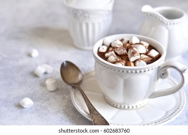 Hot Chocolate With Mini Marshmellow In A White Vintage Cup On A Light Slate,stone Or Concrete Background.