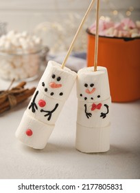 Hot chocolate mug and a snowman made of marshmallows.Cocoa drink.Sweet treat for kids funny marshmallow snowman. Christmas winter holiday decoration. New Year card.Winter hot drink.