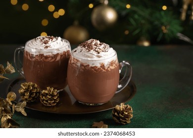 Hot chocolate with whipped cream in glass cups. Dark background with garland lights bokeh. Christmas and New Year sweet dfink and food holiday concept - Powered by Shutterstock