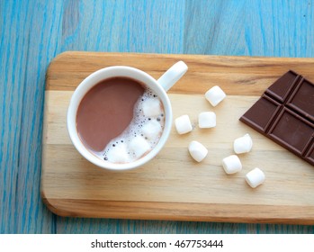 Hot Coco Hot Chocolate In Mug With Marshmallows And Chocolate Bar On The Side Of The Mug On A Wooden Board On A Green Wooden Background/hot Chocolate/mug Of Hot Chocolate