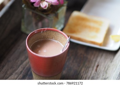 A Hot Coco Mug And A Bread.