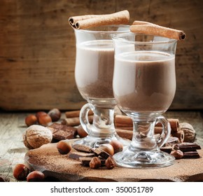 Hot cocoa with cinnamon, chocolate and nuts, selective focus - Shutterstock ID 350051789