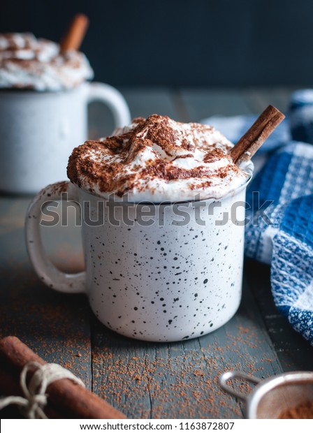 Hot Cocoa With Whipped Cream And Cinnamon Stick On Dark Background