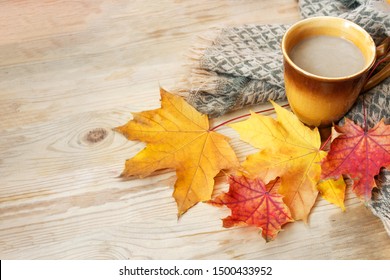 hot coffee or cappuccino and autumn leaves on a wooden table with copy space, autumn comes soon, Autumn decor, fall mood, autumn still life