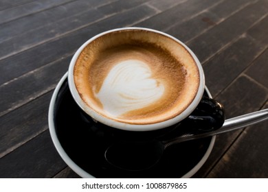 Hot coffee cup on a wooden table. - Shutterstock ID 1008879865