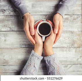 Hot coffee in the hands of a loved one.