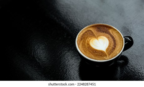 hot coffee latte art heart shape on black table - Shutterstock ID 2248287451